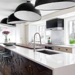 Bright horizontal image of a modern domestic kitchen, with large marble island and overhead dome lighting